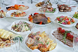 Beautiful festive table served for wedding celebration dinner at home or restaurant interior. Table full of food at a restaurant.