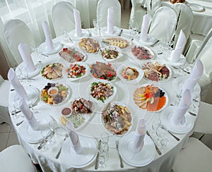 Beautiful festive table served for wedding celebration dinner at home or restaurant interior. Table full of food at a restaurant.