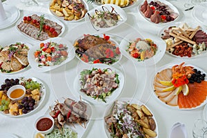 Beautiful festive table served for wedding celebration dinner at home or restaurant interior. Table full of food at a restaurant.