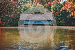 The old wooden house on the lake in the autumn season