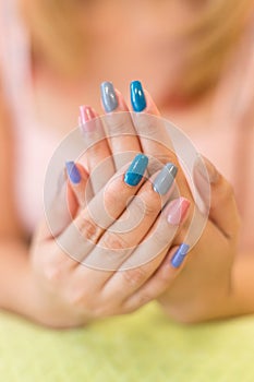 Beautiful fingernail manicure acrylic nail polish of woman