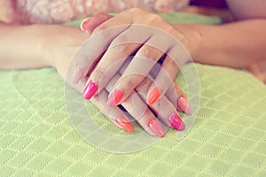 Beautiful fingernail manicure acrylic nail polish of woman