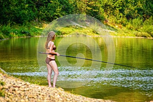 Beautiful fishing young woman