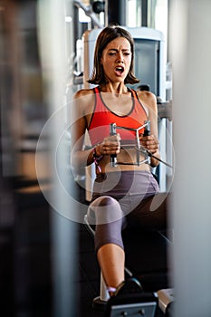 Beautiful fit fitness woman exercising in gym to stay healthy