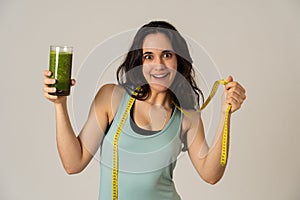 Beautiful fit sport latin woman dieting drinking healthy fresh vegetable smoothie feeling healthy