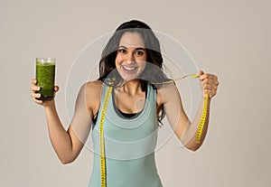 Beautiful fit sport latin woman dieting drinking healthy fresh vegetable smoothie feeling healthy