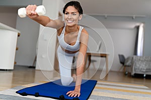 Beautiful fit woman exercise fitness at home instead of going to the gym.