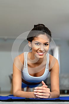 Beautiful fit woman exercise fitness at home instead of going to the gym.