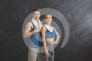 Beautiful fitness couple standing at gym