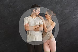 Beautiful fitness couple standing at gym