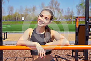 Beautiful fitness girl doing exercises in stylish sportswear  outdoors.