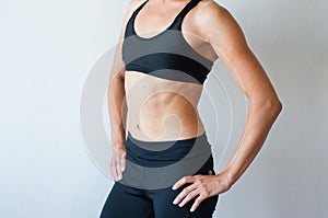 Beautiful fitness girl posing. Active girl doing front forward one leg step lunge exercise for butt, isolated