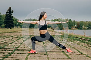 Beautiful fitness girl posing on blue wall background outdoors  copy space. Sporty woman with perfect body  healthy lifestyle and photo