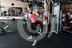 Beautiful fitness woman lifting barbell.