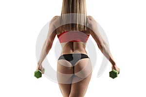 Beautiful fitness woman lifting dumbbells