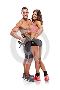 Beautiful fitness young sporty couple with dumbbell