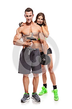 Beautiful fitness young sporty couple with dumbbell