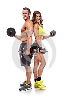 Beautiful fitness young sporty couple with dumbbell