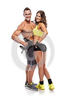 Beautiful fitness young sporty couple with dumbbell