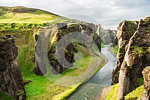 Beautiful Fjadrargljufur canyon with river and big rocks