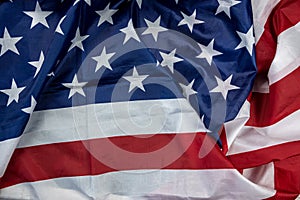 beautiful flag of the United States of America laid out textured on a plain background.