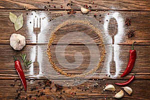 Beautiful flat lay composition with different spices, silhouettes of cutlery and plate on wooden background. Space for text