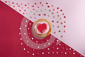 Beautiful flat lay pattern of hearts with cupcakes with cream and a red heart