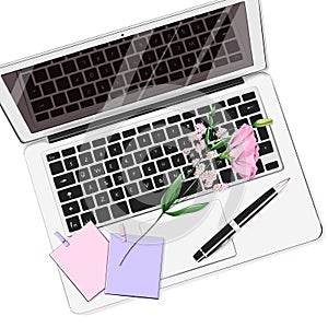 Beautiful flat lay set with laptop, pen, stickers and flower. Notebook with keyboard on table.