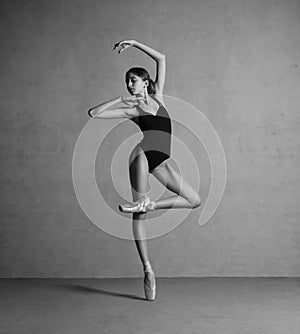Beautiful flexible ballerina dancing in black swimmwear