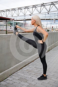 Beautiful and Flexible Blonde Woman Stretching In Modern City