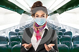 A beautiful flight attendant with surgical mask, multicolored scarf and black jacket. Subject on a blurred background. Perfect