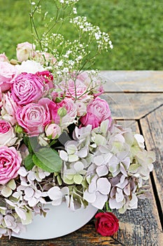 Beautiful floral arrangement with pink roses, hortensia and gypsophila paniculata