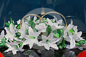 Beautiful floral decoration is on a wedding car.