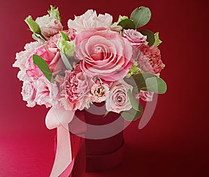 Beautiful flower box on red background, bouquet of blooming flowers as holiday gift, luxury floral design