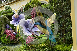 a beautiful flower garden with a hummingbird at Bellagio Conservatory and Botanical Gardens with colorful flowers