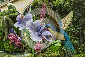 a beautiful flower garden with a hummingbird at Bellagio Conservatory and Botanical Gardens with colorful flowers