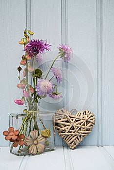 Beautiful flower in vase with heart still life love concept