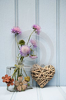 Beautiful flower in vase with heart still life love concept