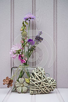 Beautiful flower in vase with heart still life love concept