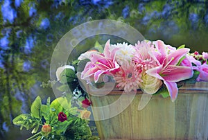 beautiful flowers arrangement in wood bucket with blurry background