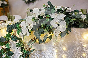 Beautiful flowers on elegant dinner table in wedding day. Decorations served on the festive table in blurred background