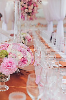 Beautiful flowers and glasses in roll romantic wedding table decorations