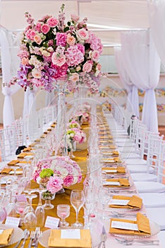 Beautiful flowers and glasses in roll romantic wedding table decorations