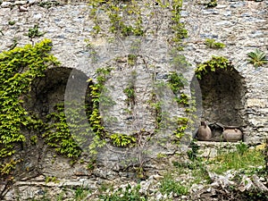 beautiful flowers in an old stone window in Ticino on the roadside near Lugano.