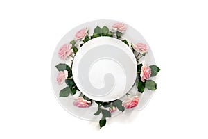 Beautiful flowers pink roses with white circle paper card note with space for text on white background. Top view, flat lay