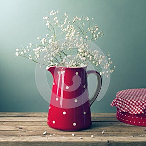 Beautiful flowers in red jug