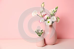 Beautiful flowers in vases and space for text