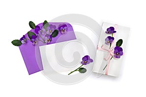 Beautiful flowers viola tricolor  pansy  in postal envelope with blank sheet and white gift box with pink ribbon and bow