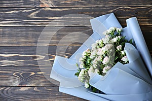 Beautiful flowers on wooden background. Roses bouquet. Perfect flat lay with petals. Happy mother`s holiday postcard.