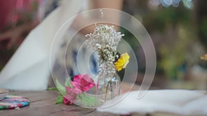 Beautiful flowery decorations on a wooden dining table outdoors